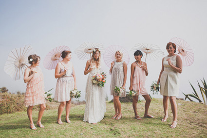 Pink and cream bohemian bridesmaids with pink umbrellas