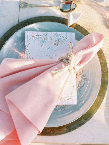 Nautical wedding place setting with pink napkin