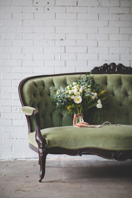 Green vintage couch with bouquet