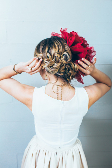 Bridal hairstyle with red flower headpiece