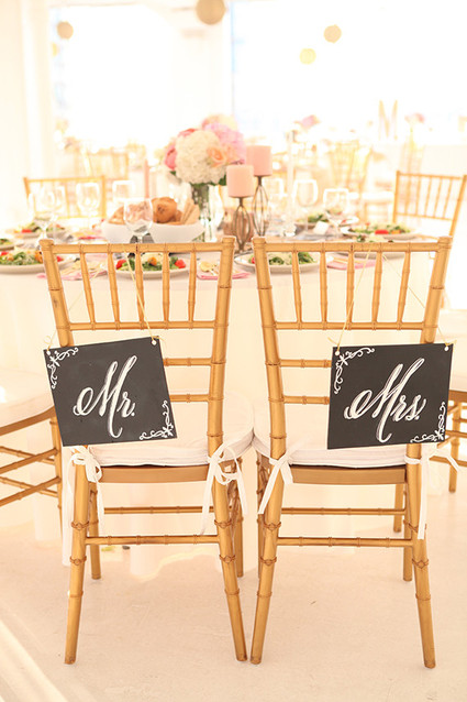 Mr. and Mrs. signage on gold chairs