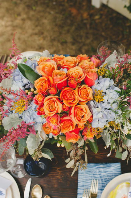 Orange rose and blue floral centerpiece