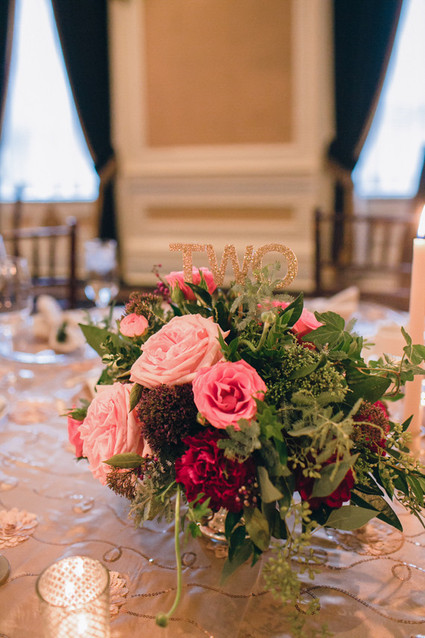 Pink and red centerpiece with gold table number Inspiration