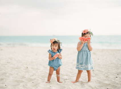 little girls on the beach with flower crowns and watermelon