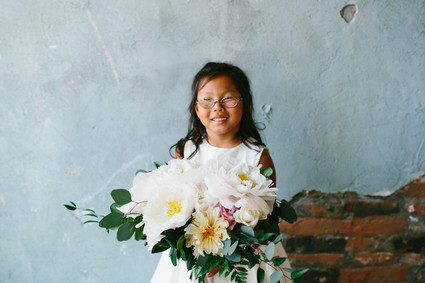 flower girl with brides bouquet