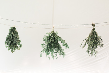hanging bunches of herbs in wedding decor