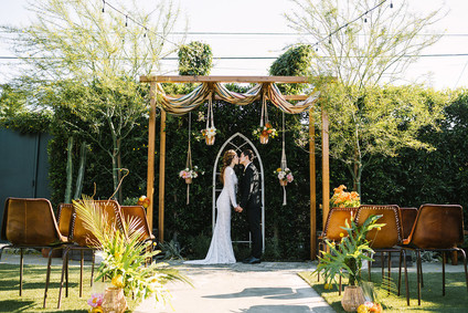 eclectic ceremony decor with macrame plant holders Inspiration