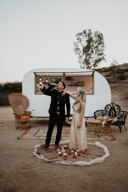 Boho vow renewal with a palm frond teepee at Wolf Feather Honey Farm