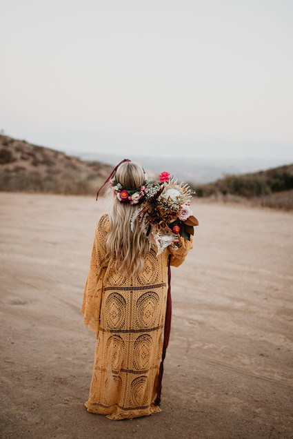 Boho vow renewal with a palm frond teepee at Wolf Feather Honey Farm