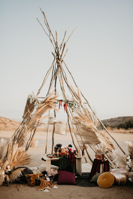 Boho vow renewal with a palm frond teepee at Wolf Feather Honey Farm