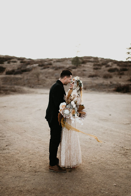 Boho vow renewal with a palm frond teepee at Wolf Feather Honey Farm