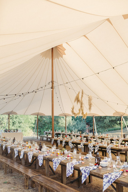 rustic wedding tent with hand-dyed napkins and pampas grass wreaths