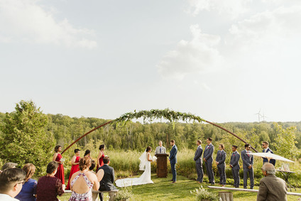 Farm to table summer barn wedding with pops of red and a PARADE