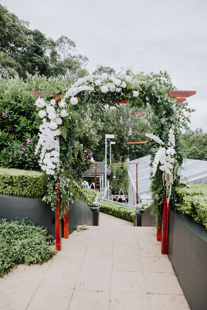 Green and white wedding arch