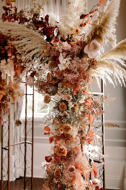 Lush fall floral ceremony arch with pampas