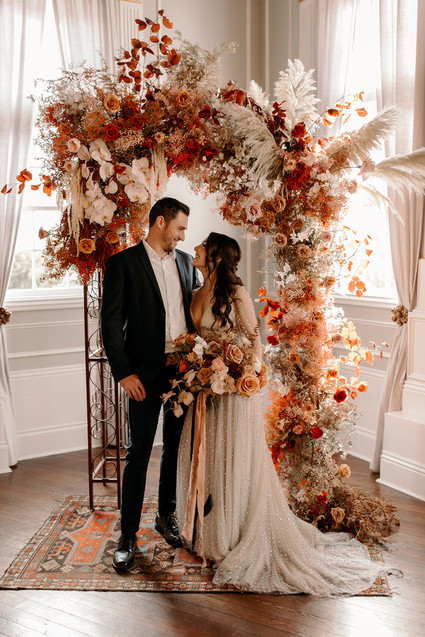 Lush fall floral ceremony arch