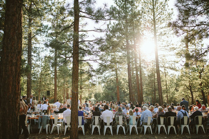 long reception table in forest wedding