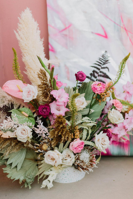 Painted wedding backdrop and flowers