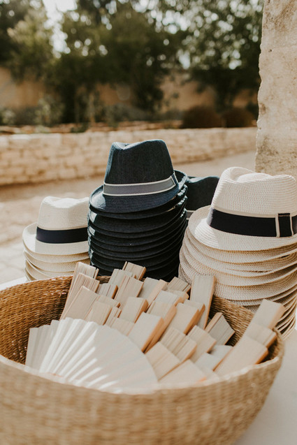 hat and fans for wedding ceremony