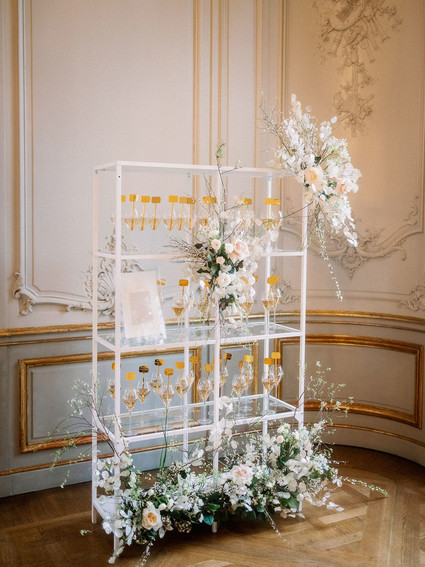 Champagne escort card display with gold drink stirs