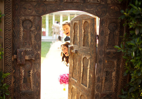 Bride and Groom Peeking Behind Doorway Portait