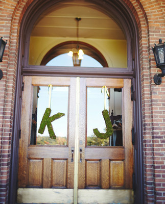 Green initials hanging from door