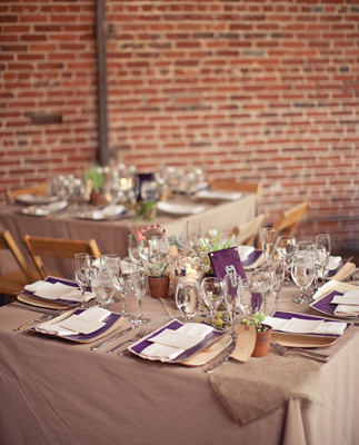 Square reception tables with purple napkin accents