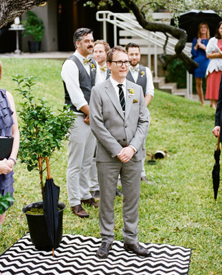 Groom standing on chevron rug
