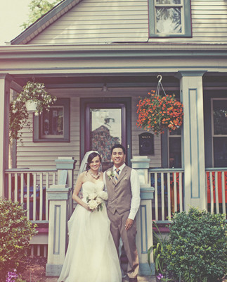 Groom and bride portrait in front of house