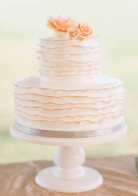 delicate two-tiered cake with simple rose topper
