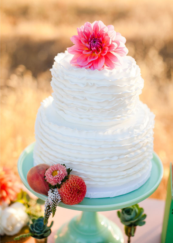 White wedding cake with flower topper