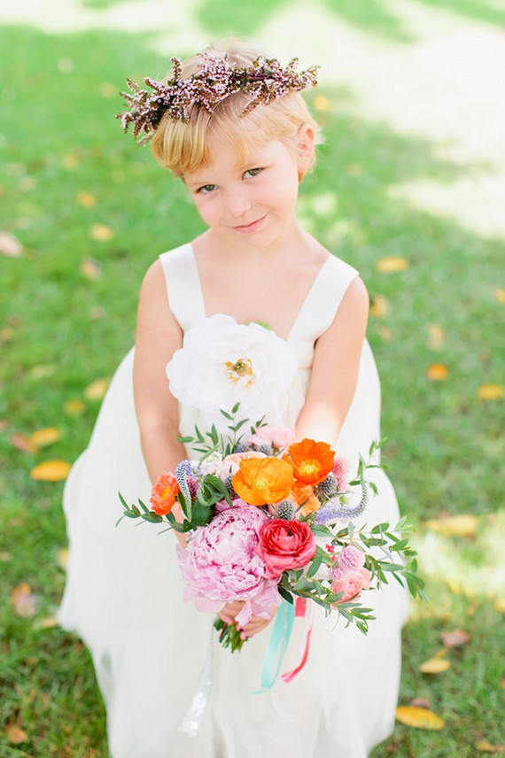 Flower girl with small colorful bouquet