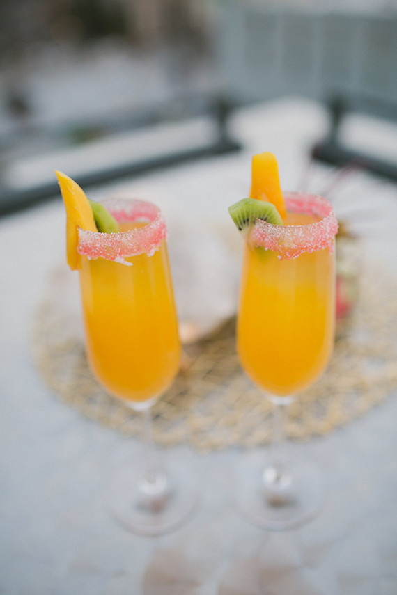 Orange cocktail with pink sugar rim