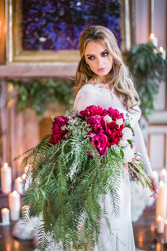 Elegant bride with red and green bouquet