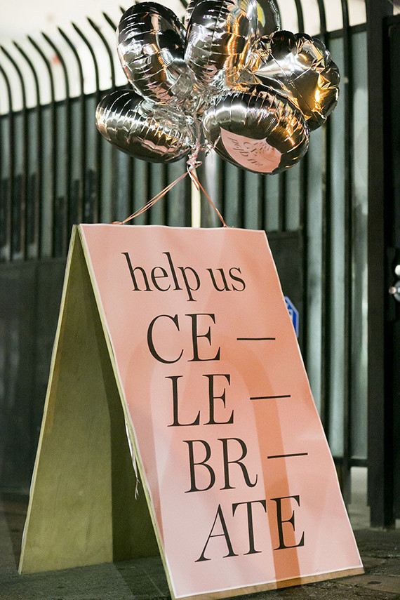 Celebrate sign with silver balloons