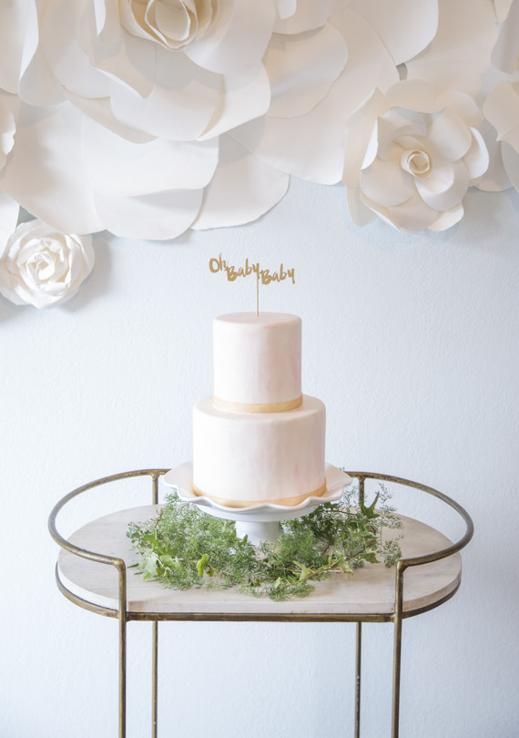 Baby shower cake with paper flower backdrop
