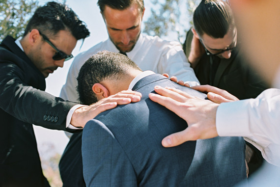 Groomsmen pray