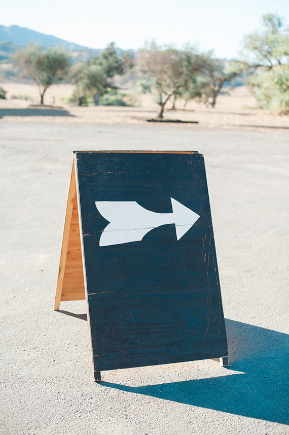 Wooden black and white arrow sign