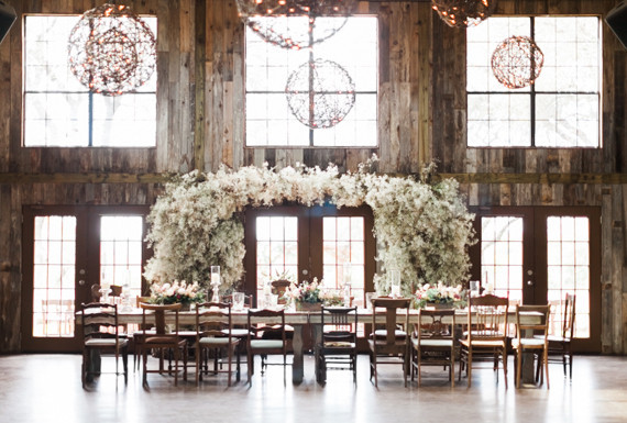 Rustic indoor wedding with floral arch