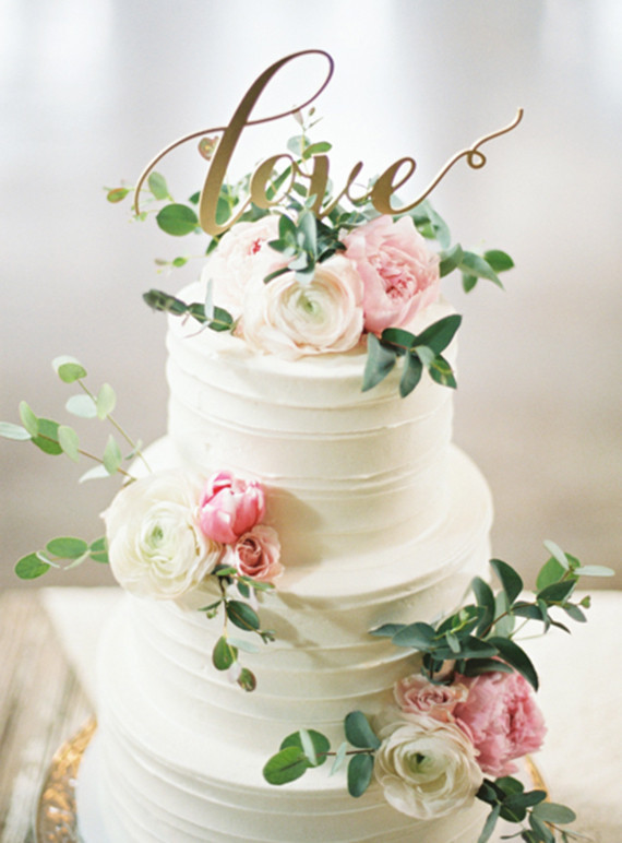 White floral cake with love signage