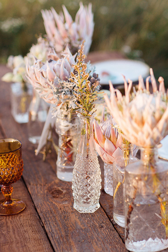 Clear vases with pastel protea
