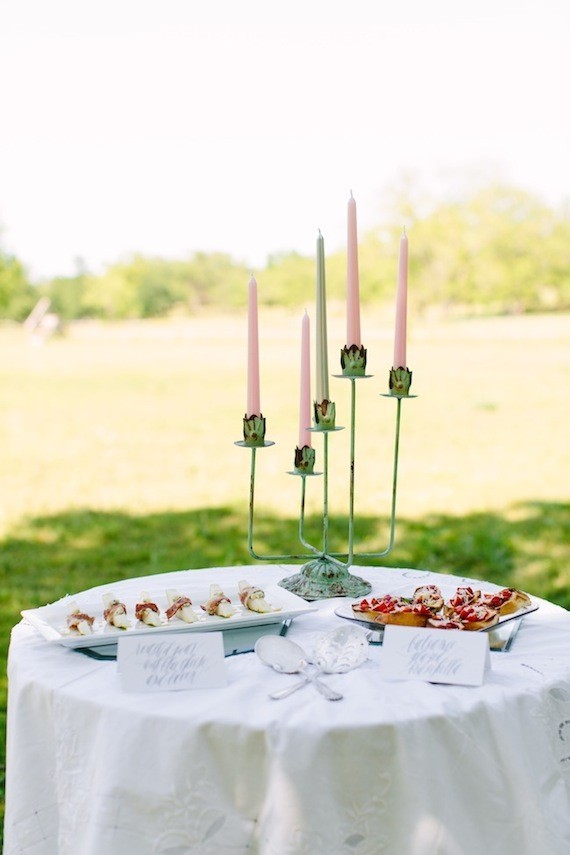 Wedding food table with high candles