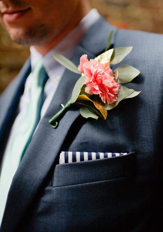 Pink boutonniere with navy suit