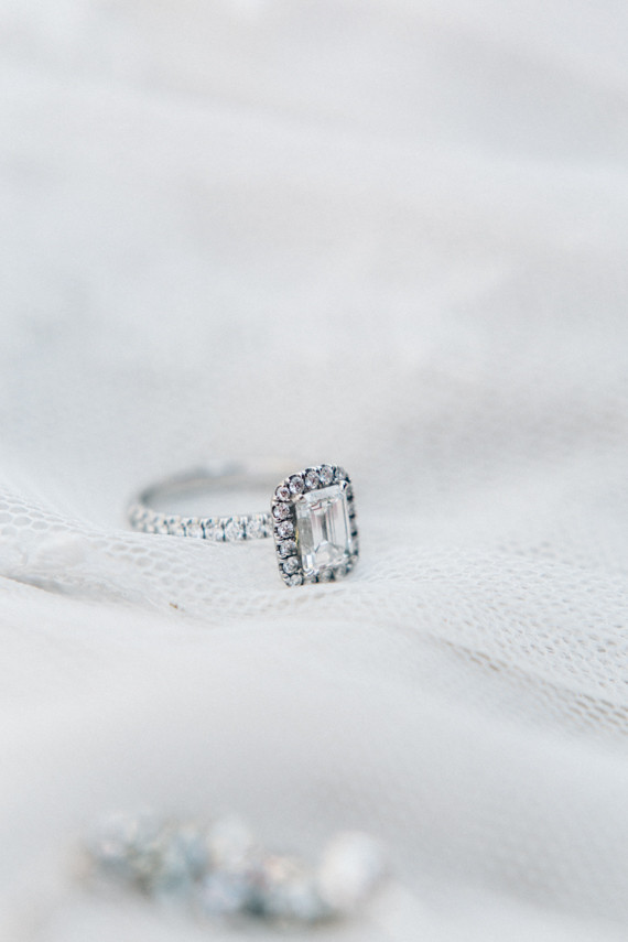 Emerald cut diamond with halo and platinum band