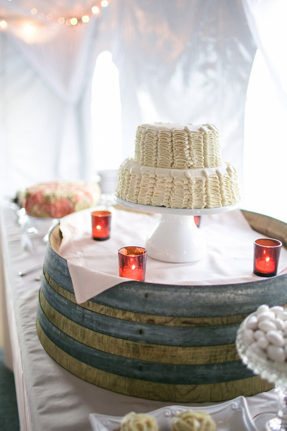 White ruffled cake with barrel stand