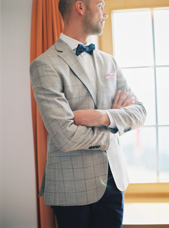Groom with grey suit and blue bow tie