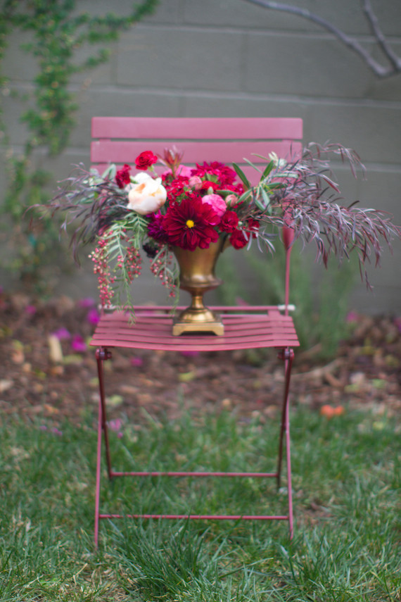 Gold vase with pink floral centerpiece