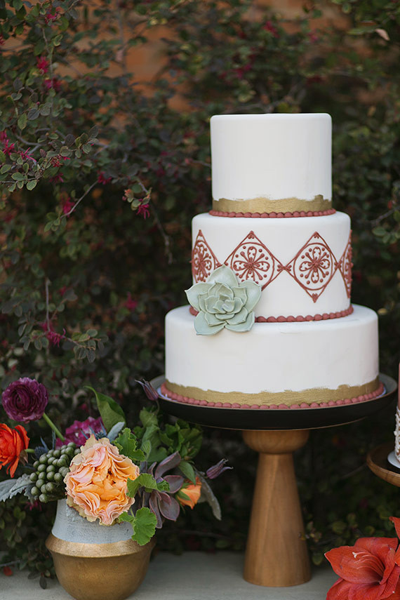 Spanish inspired white cake with green floral decor