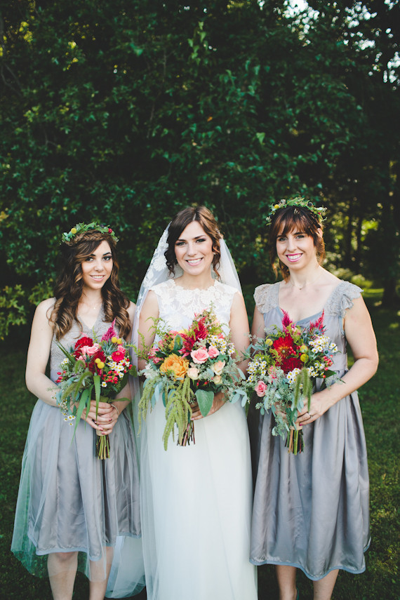 Bridesmaid in grey dresses with colorful bouquets