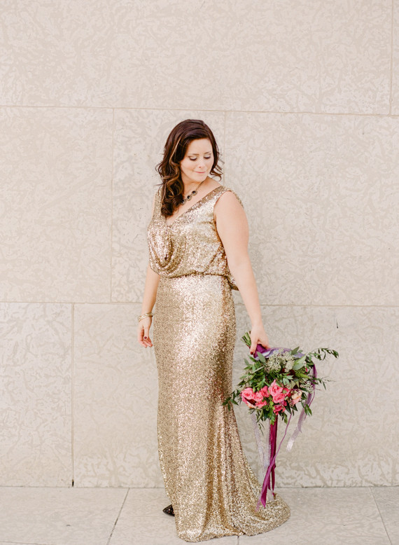 Gold wedding dress with pink bouquet